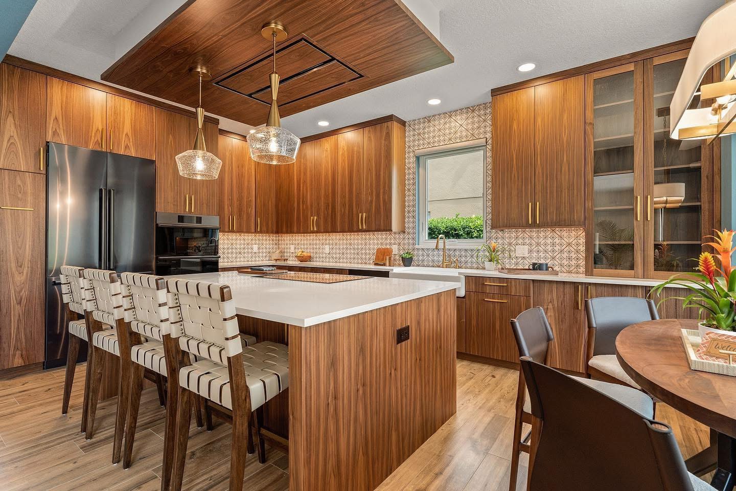 Mid-century modern kitchen remodel with walnut cabinetry and white quartz countertops